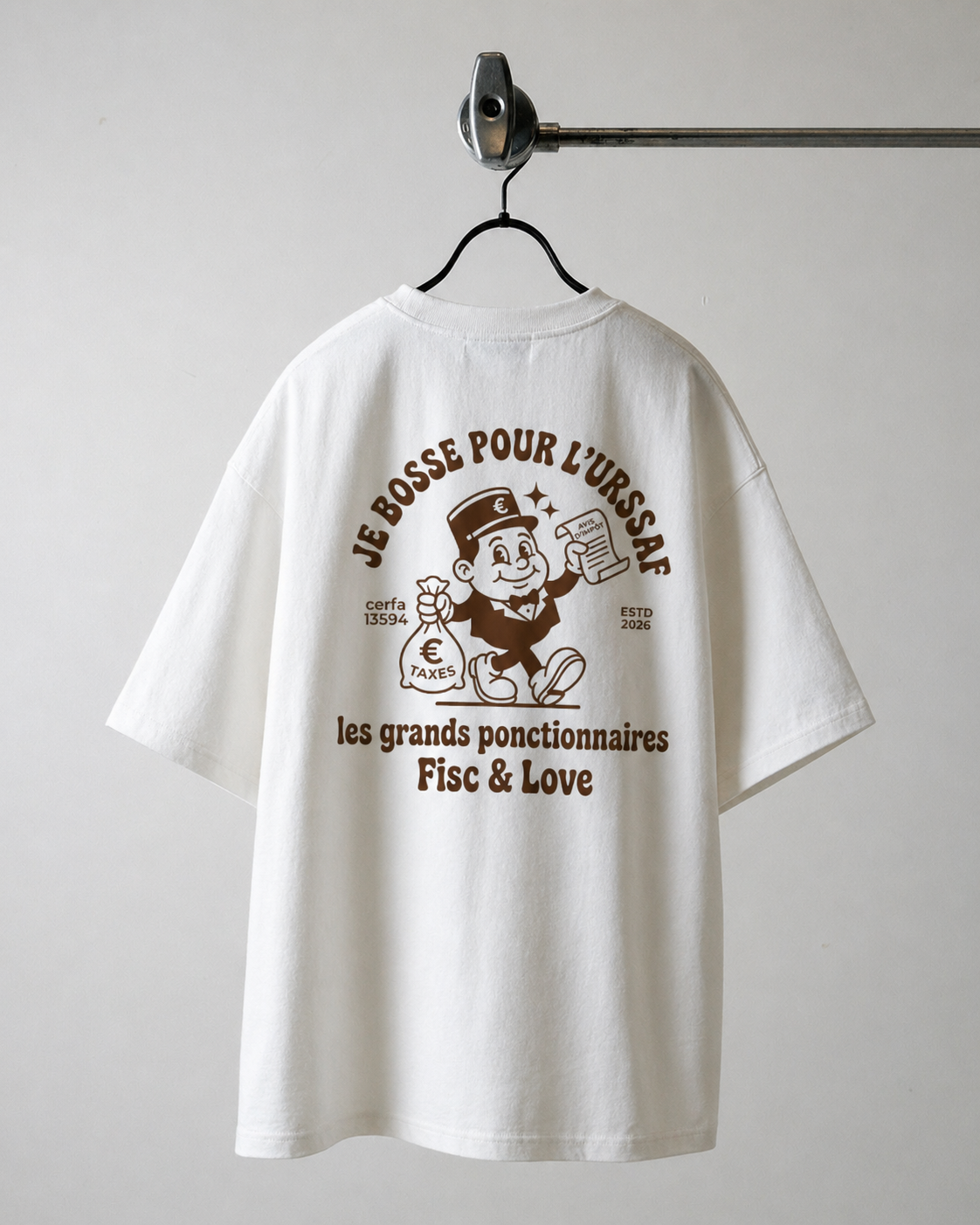 Dos d'un t-shirt humour fiscal blanc oversize de la marque Fisc & Love avec une illustration rétro d'un personnage portant un sac de taxes. Inscriptions : 'Je bosse pour l'URSSAF' et 'Les grands fonctionnaires'."